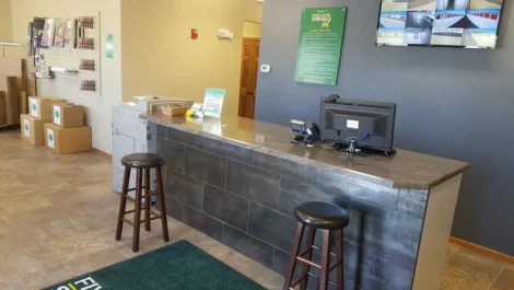 Reception area of a storage facility with a desk and security system.