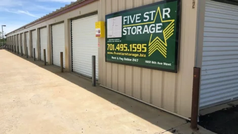 Line of storage units with a clear view of the Five Star Storage sign.