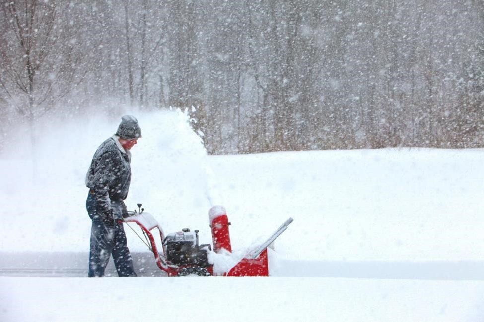 A man using a snowblower