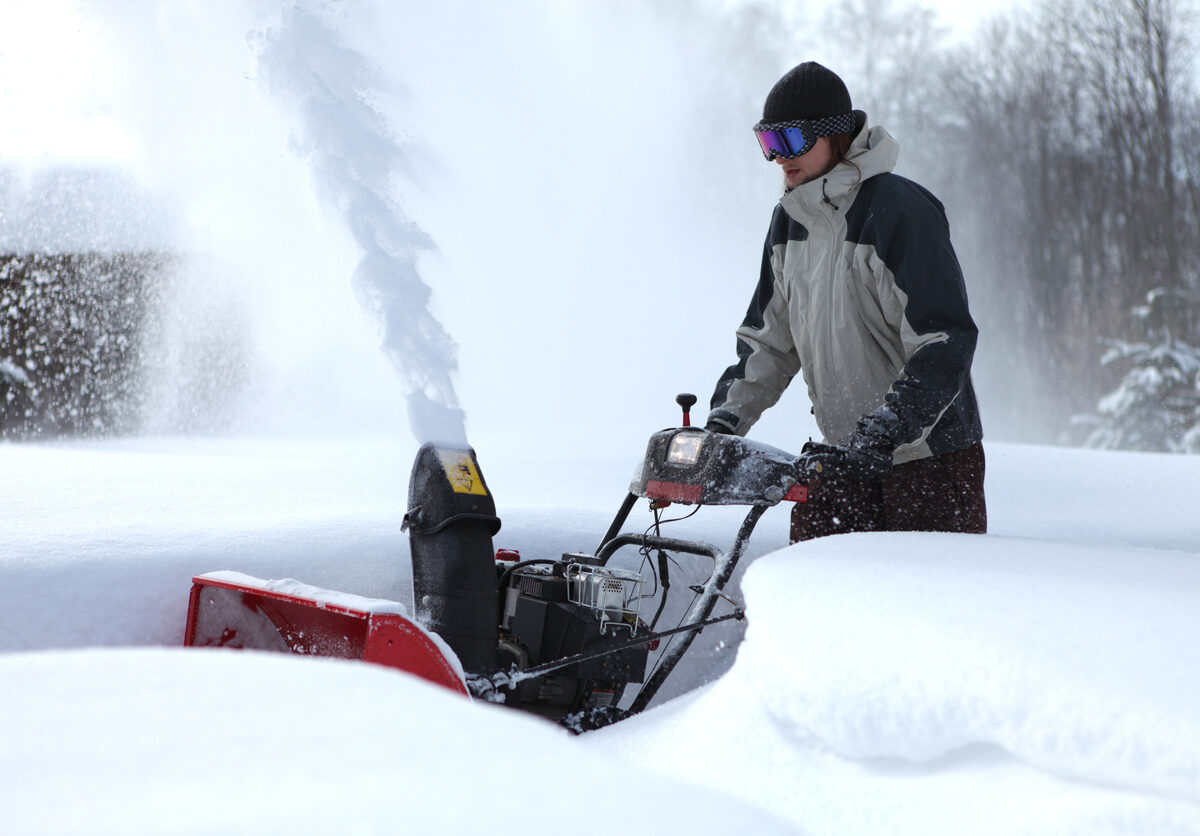 Man using a snow blower.