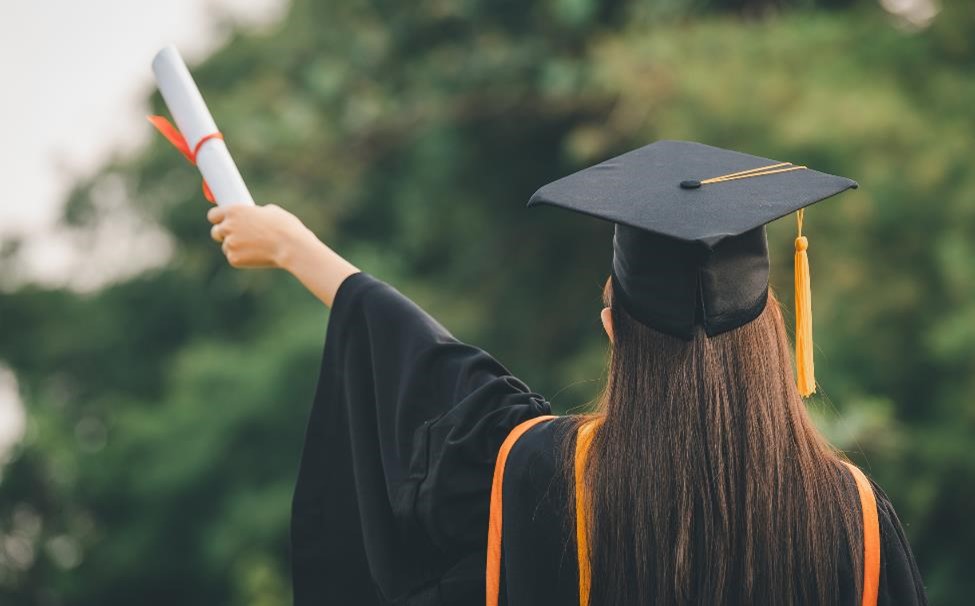 A woman and a diploma.