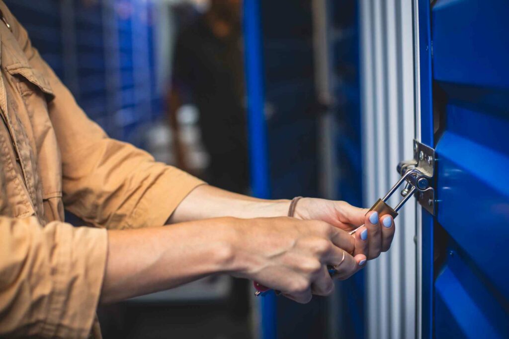 A woman locking her self-storage unit. 