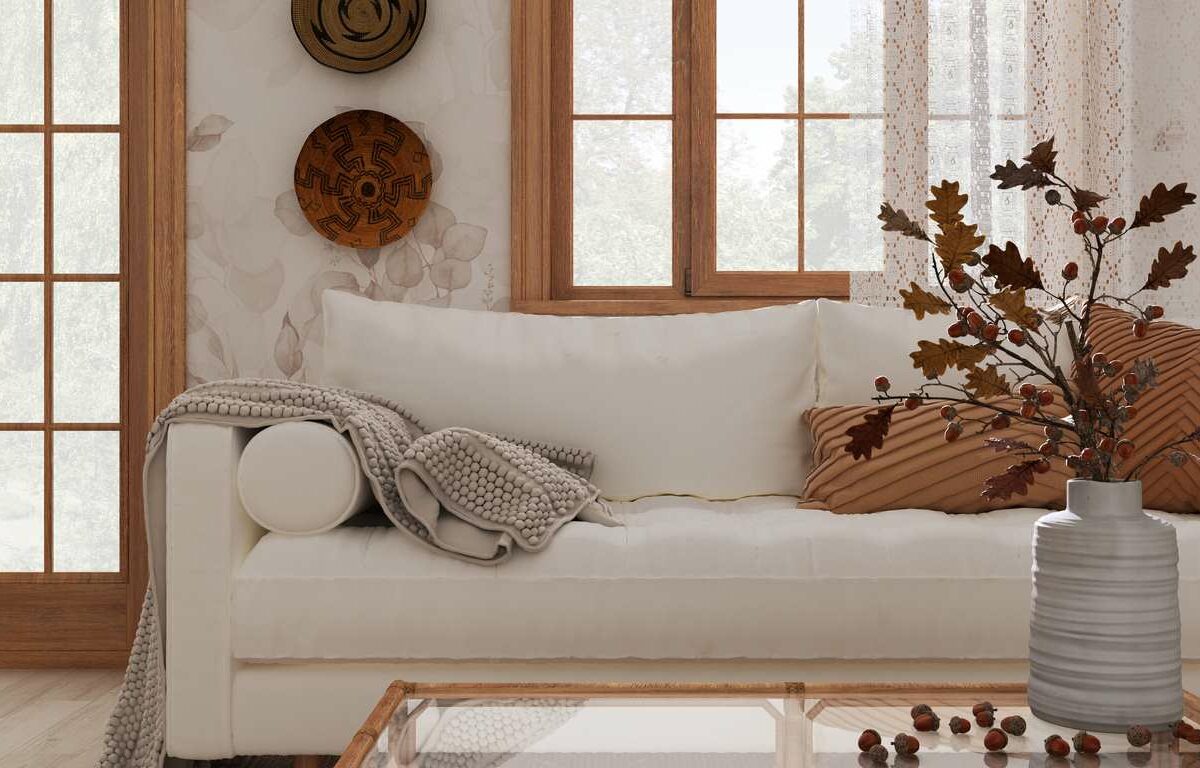 A sofa with light touches of fall accents throughout the room.