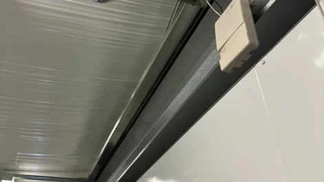 Close-up of a storage unit door track and control system for smooth operation.