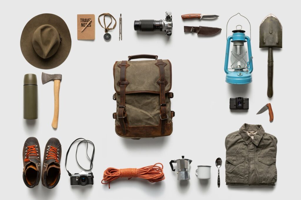 A backpack surrounded by other outdoor gear and equipment against a white background.