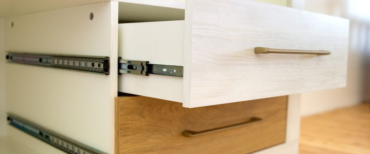 White and tan desk drawers with one open to fit a load of items.