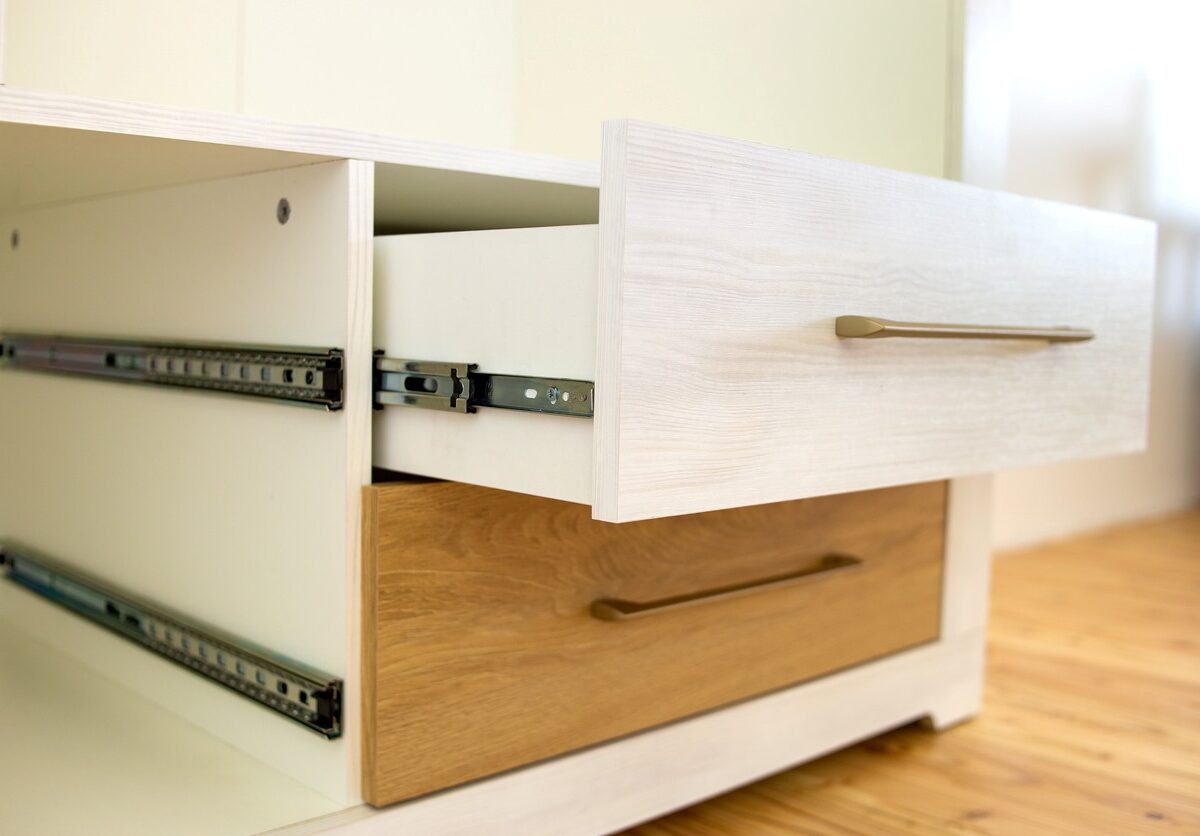 White and tan desk drawers with one open to fit a load of items.