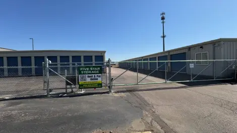 Entrance to Five Star Storage with a security gate and rows of storage units.