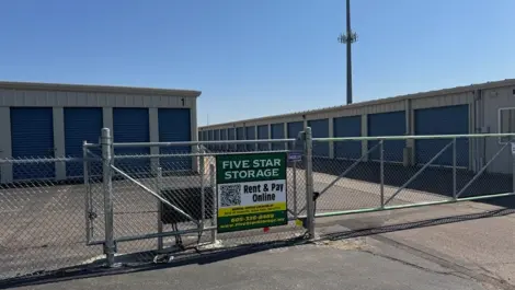 Five Star Storage entrance with a sign and storage units in the background.