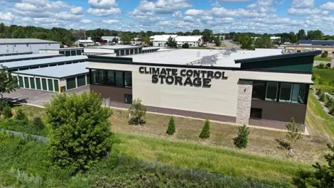 Arial view of Climate Control Storage building with modern design and green landscape.