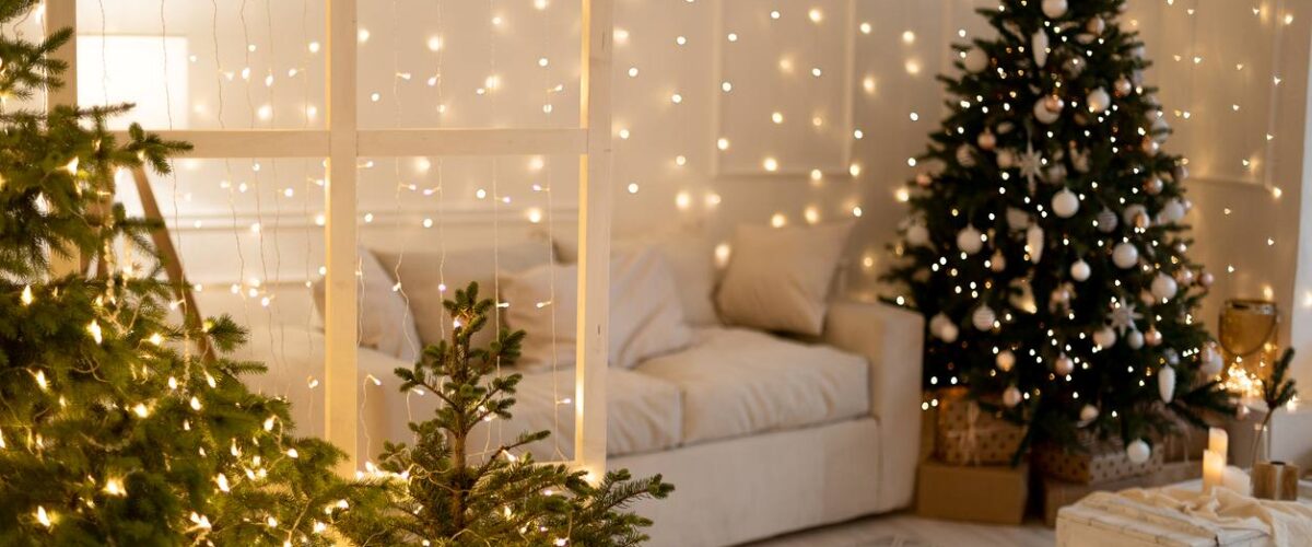 A Christmas tree and decorations on display in a cozy living room.