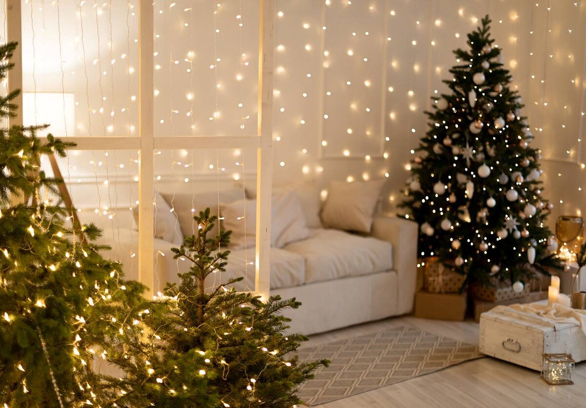 A Christmas tree and decorations on display in a cozy living room.